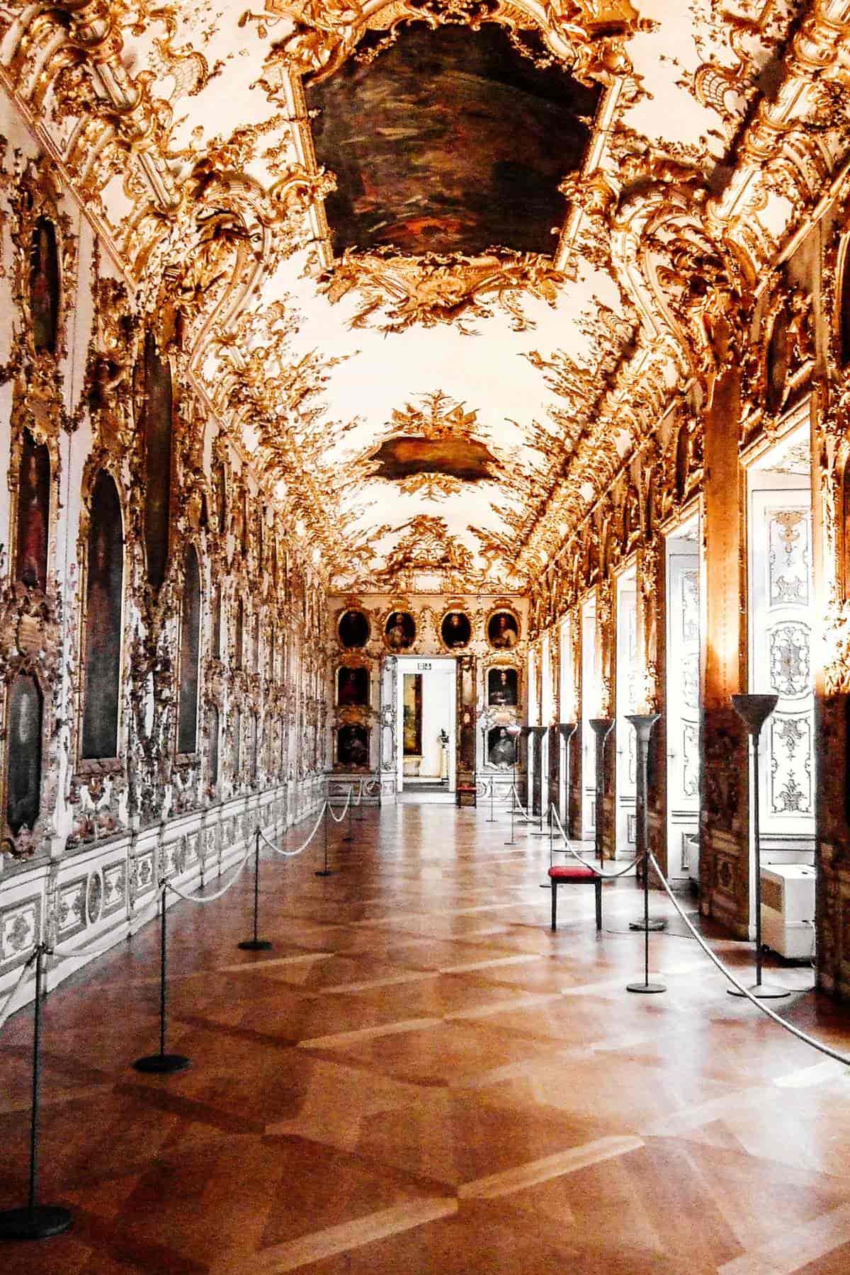 Inside the Residenz Palace ballroom with opulent decorations of gold and silk.