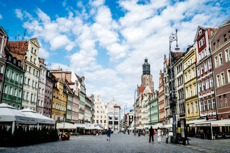 Wroclaw main square lined with colourful buildings. 